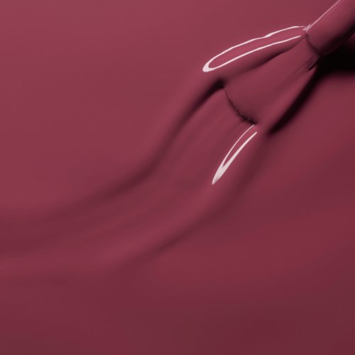 A pink lipstick is applying gloss on lips with a smooth background.