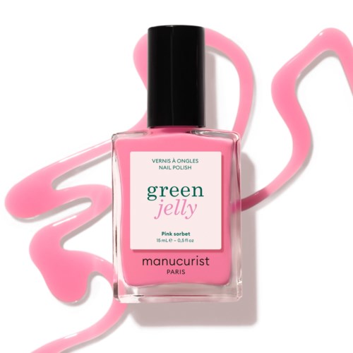 A pink nail polish bottle labeled Green Jelly and Manucurist, with pink glaze design behind it.