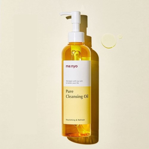 Eine gelbe, transparente Flasche mit Pumpzer, gekennzeichnet 'Pure Cleansing Oil', steht vor hellem Hintergrund.