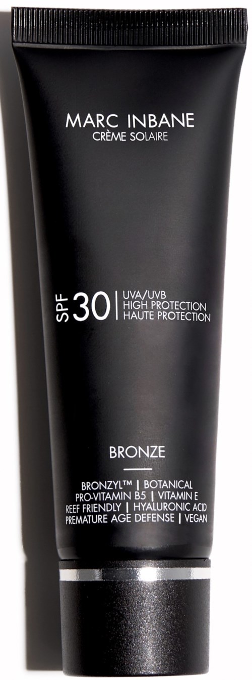 Black sunscreen tube with white text, SPF 30, and mentions of natural ingredients and vegan. Marc Inbane Creme Solaire.