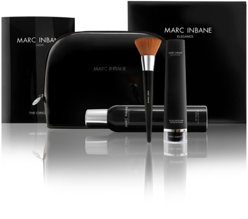 A set of Marc Inbane skincare products with a brush, tube, pouch, and boxes, all in black packaging.