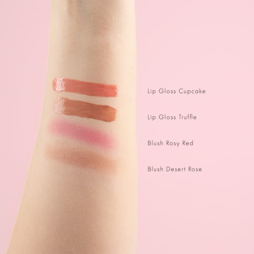 Four types of makeup swatches on skin labeled as Lip Gloss Cupcake, Lip Gloss Truffle, Blush Rosy Red, and Blush Desert Rose.
