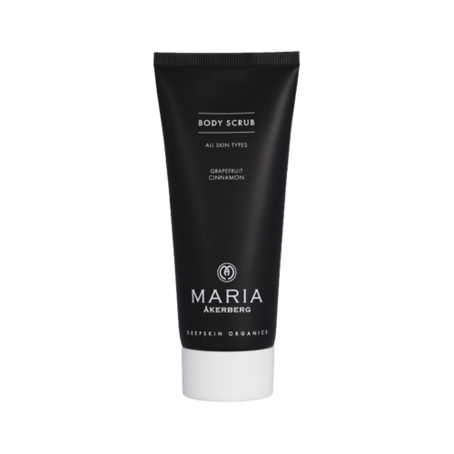 Ett svart och vitt rör med texten "body scrub" och doft av grapefrukt och kanel, för alla hudtyper.