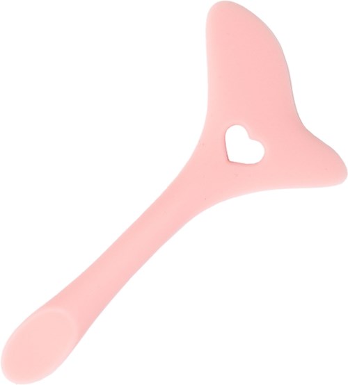 A pink plastic object with a handle and a heart-shaped cutout, shaped like a small shovel or scoop.
