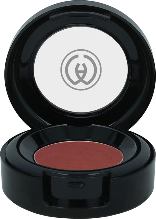 A round makeup compact with reddish powder inside, open lid shows a logo on the inside.