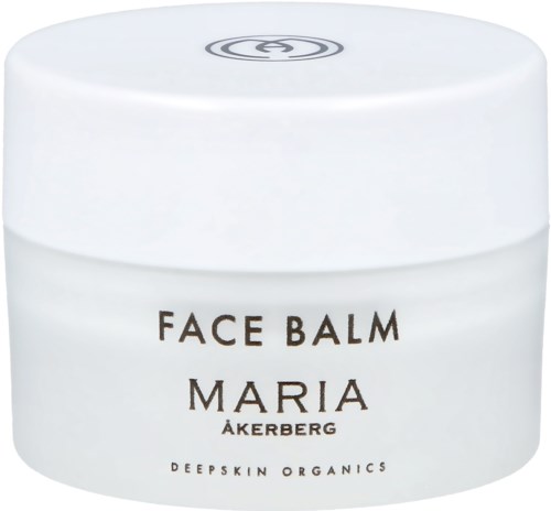 Ein weißer Behälter mit der Beschriftung 'Face Balm Maria Åkerberg' und einem schlichten schwarzen Logo auf dem Deckel.
