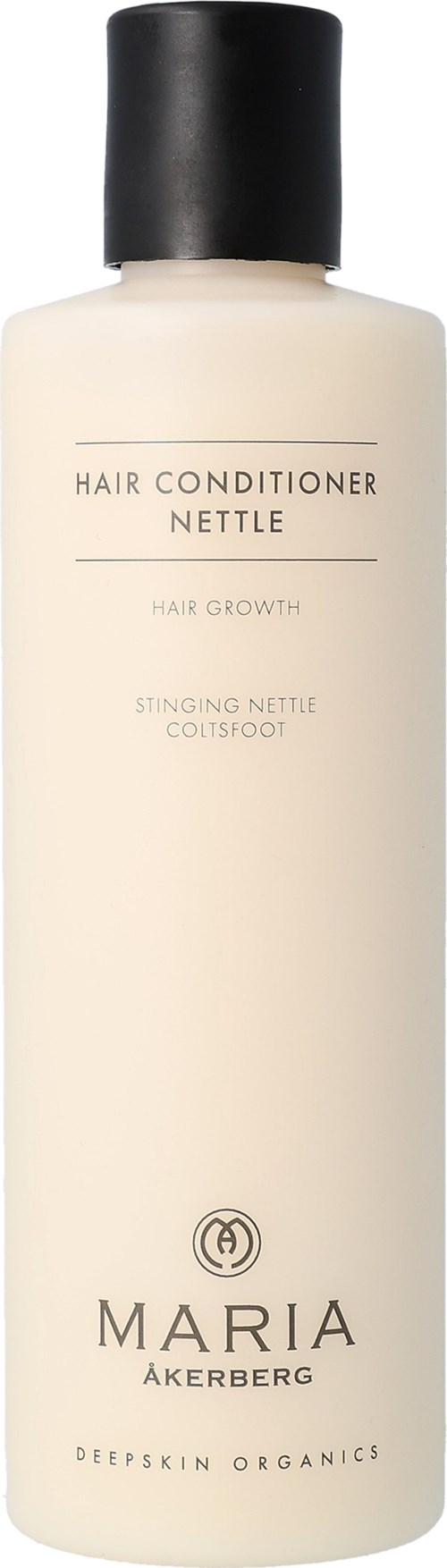Een beige fles met een zwarte dop, gemerkt als Maria Åkerberg haarconditioner met biologische ingrediënten.