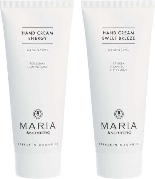 Två vita tuber handkräm med enkel svart text, märkta 'Energy' och 'Sweet Breeze' med doftdetaljer.