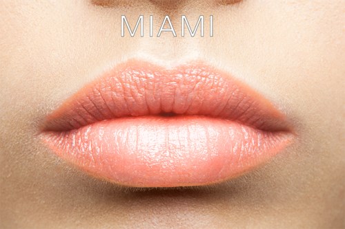 Close-up of lips with the word 'MIAMI' above them, highlighting smooth skin and pink makeup.