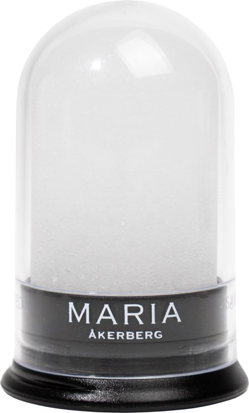 A glass dome with a black base, labeled 'MARIA ÅKERBERG', covering a white substance inside.