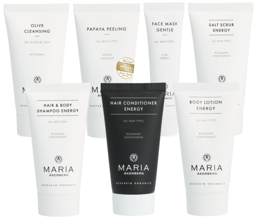 Collection of skincare and hair care tubes with white and black packaging, each labeled for different uses and ingredients.