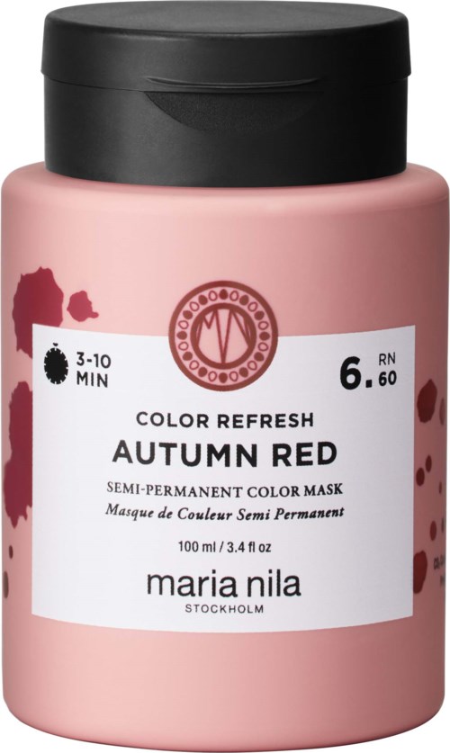 Pink bottle of semi-permanent red hair color mask labeled 'Autumn Red' by Maria Nila, with black lid and some paint splashes.