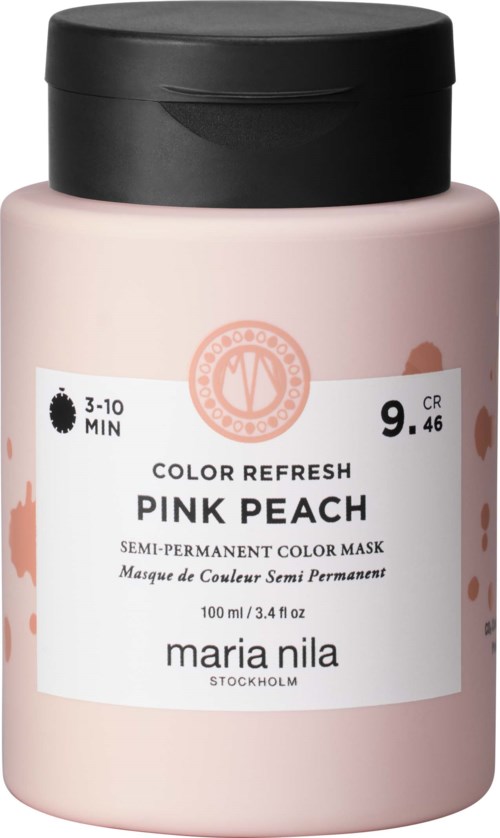 En flaska med rosa persika färgmask för hår, märkt 'Maria Nila', med svart lock.