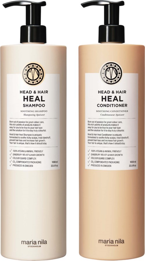 Two large bottles of hair care products, one shampoo and one conditioner, with black pump dispensers and white labels.