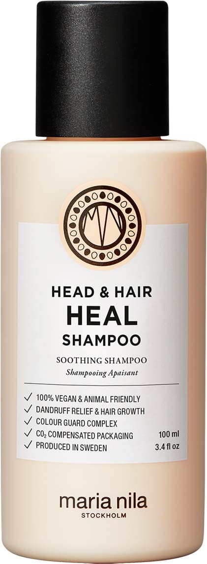 A beige bottle of Heal Shampoo for head and hair with a black cap, white label, and simple text.