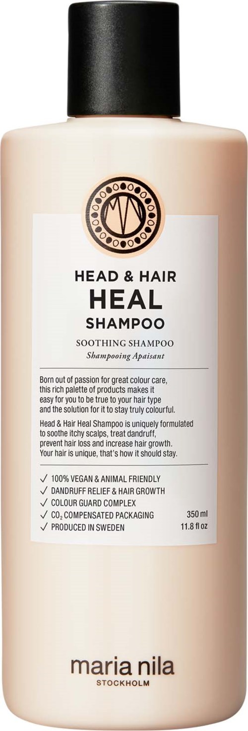 A beige bottle with a black cap, labeled as Heal Shampoo for head and hair, made by Maria Nila.