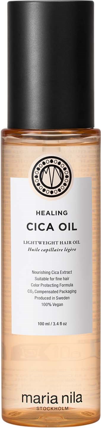 A bottle of hair oil with a black cap and a beige label that says it is healing cica oil by Maria Nila.