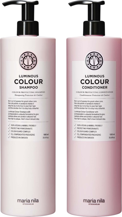 Two bottles of shampoo and conditioner with white and pink packaging, labeled 'Luminous Colour,' by Maria Nila.