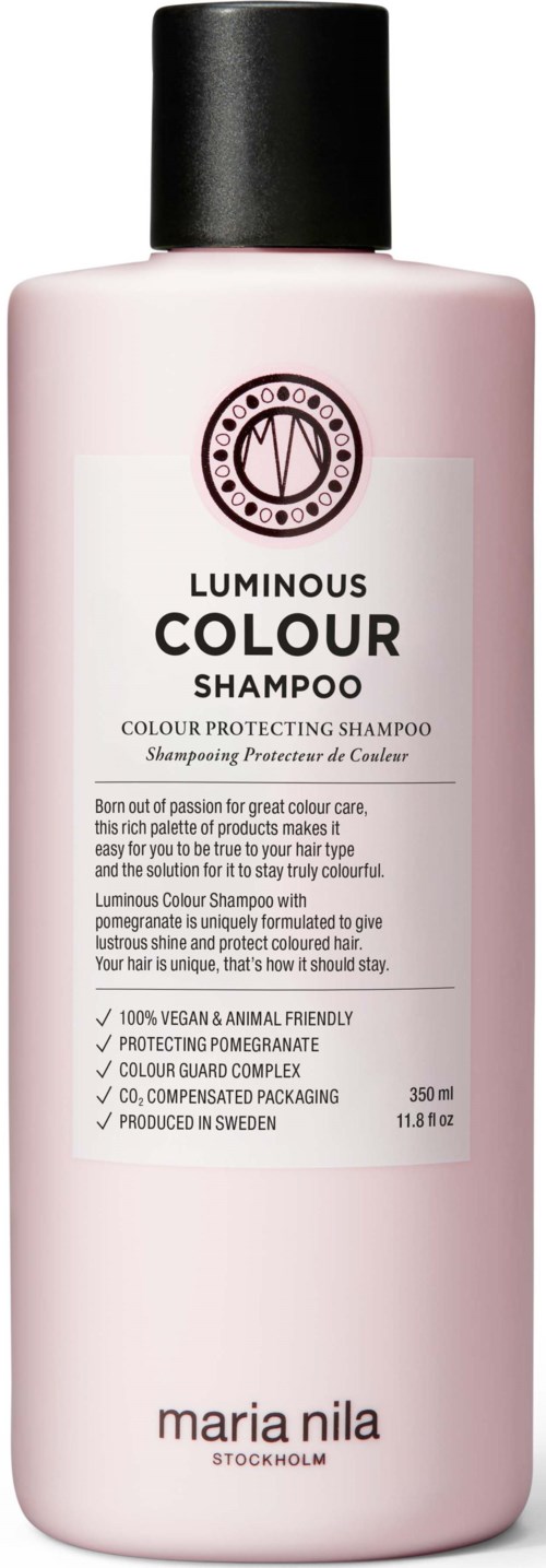 A pink bottle labeled 'Luminous Colour Shampoo' with a black cap, featuring the Maria Nila brand and details about the product.