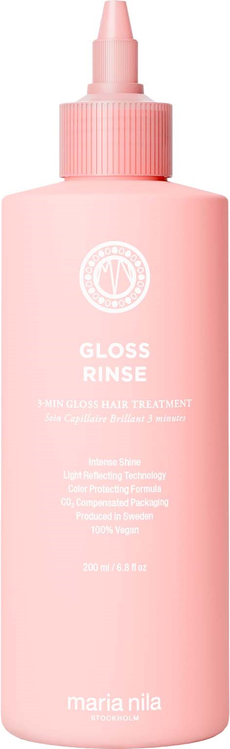 En rosa flaska med en tratt märkt Gloss Rinse och Maria Nila. Det är en hårvårdsprodukt i en lång, smal behållare.