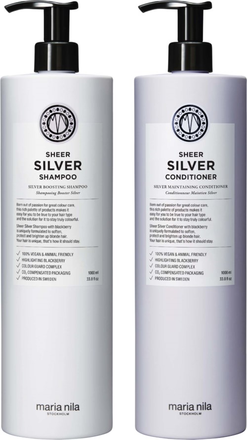 Two white bottles, one labeled shampoo and the other conditioner, with black pumps and simple labels.