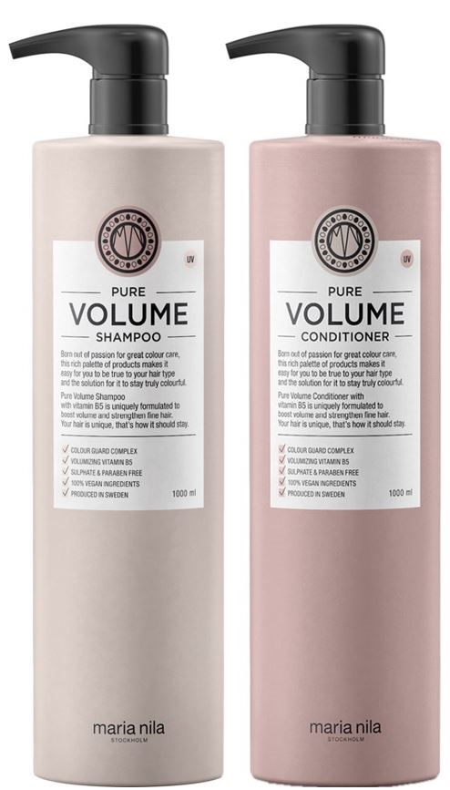 Two bottles of shampoo and conditioner, one light beige and one pink, labeled 'Pure Volume'.