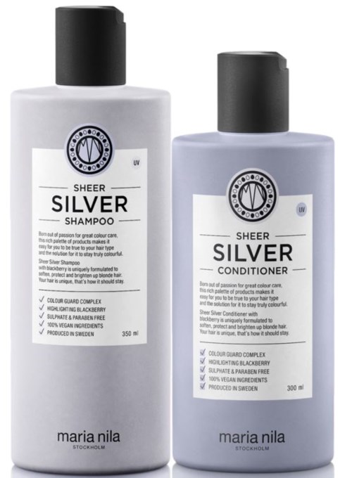Two bottles of hair care products, one shampoo and one conditioner, labeled "SILVER" by Maria Nila, white and gray bottles.