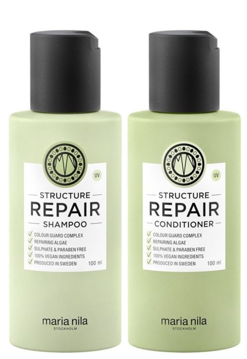 Two bottles of repair shampoo and conditioner with black caps, light green bottles, and labels showing brand and details.