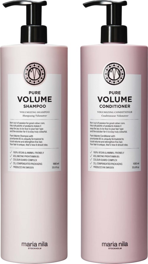 Two pink hair care bottles, one for shampoo and one for conditioner, labeled 'Pure Volume' by Maria Nila.