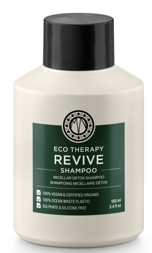 En vit flaska av Eco Therapy Revive Shampoo med svart lock och grön etikett, visar produktens egenskaper och storlek.