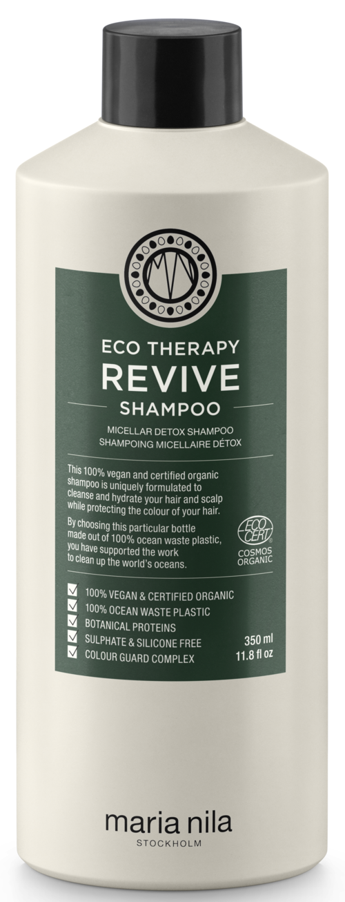 Een witte fles met een zwarte dop met label 'Eco Therapy Revive Shampoo' voor detox, biologisch, veganistisch, cruelty-free.