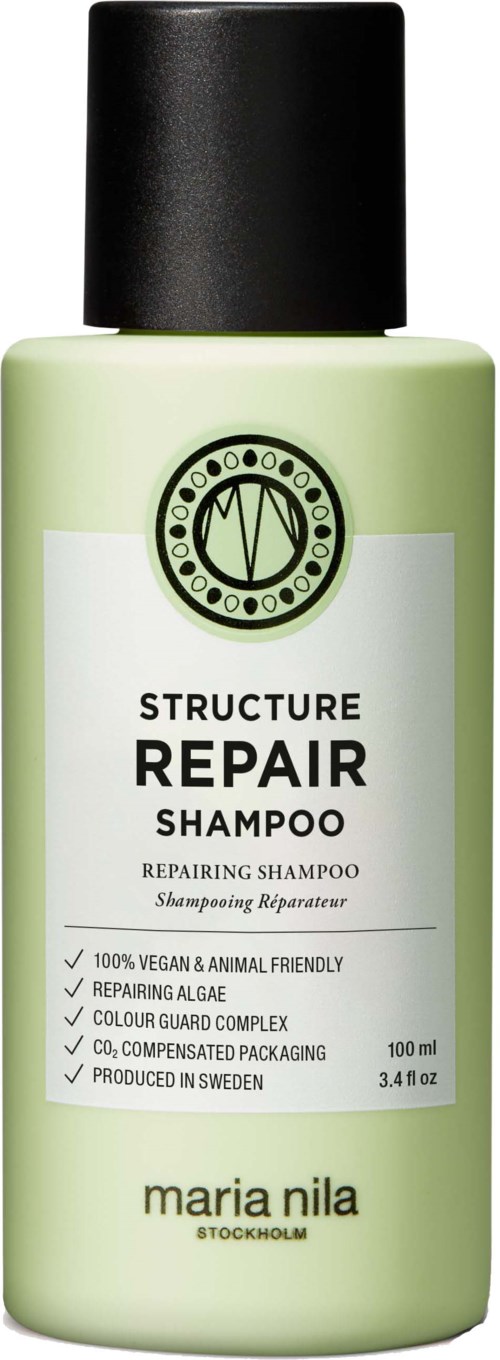 Green bottle of Maria Nila Structure Repair Shampoo with black cap, label shows product details and features.