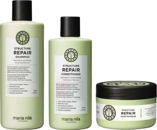 Drei Haarpflegeprodukte in grünen Flaschen und einem Tiegel, gekennzeichnet Shampoo, Conditioner und Haarmaske, von Maria Nila.