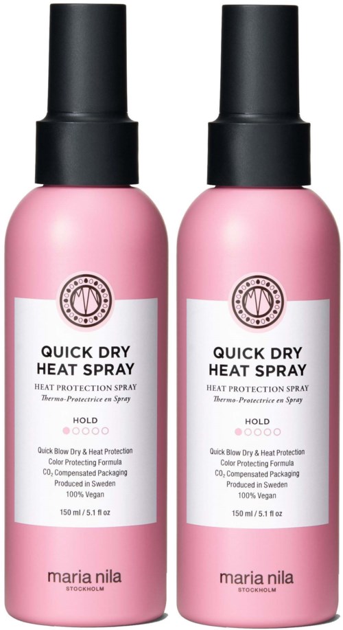 Two pink spray bottles labeled 'Quick Dry Heat Spray' by Maria Nila for heat protection and styling.