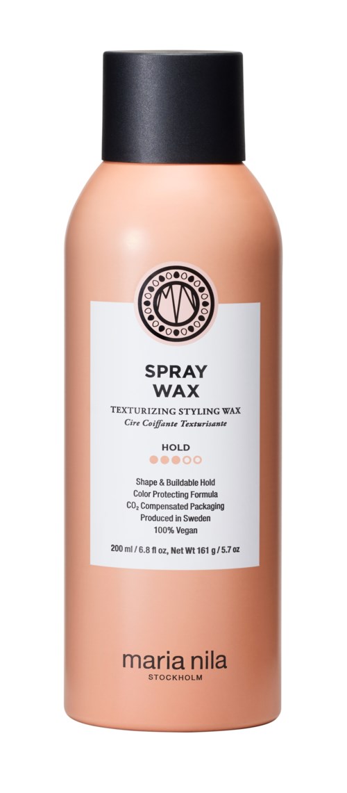 A peach-colored spray bottle with a black cap. It has a white label with text about styling wax.