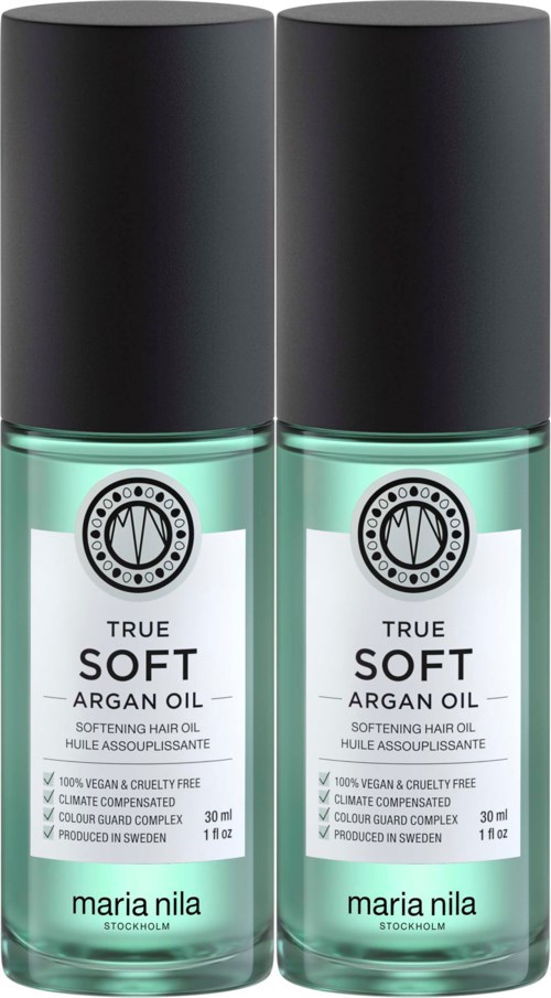 Två flaskor med mjuk arganolja för hår, med svarta lock och genomskinliga flaskor, märkta 'True Soft Argan Oil' av Maria Nila.