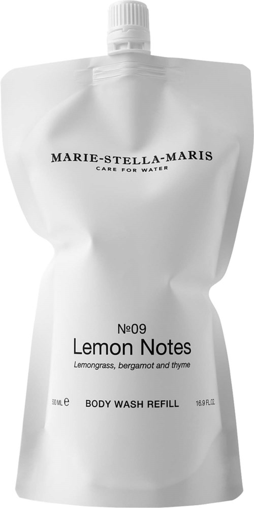 En vit påfyllningspåse för kroppstvätt med svart text och vridlock, märkt som Lemon Notes med citronmalört och timjan.
