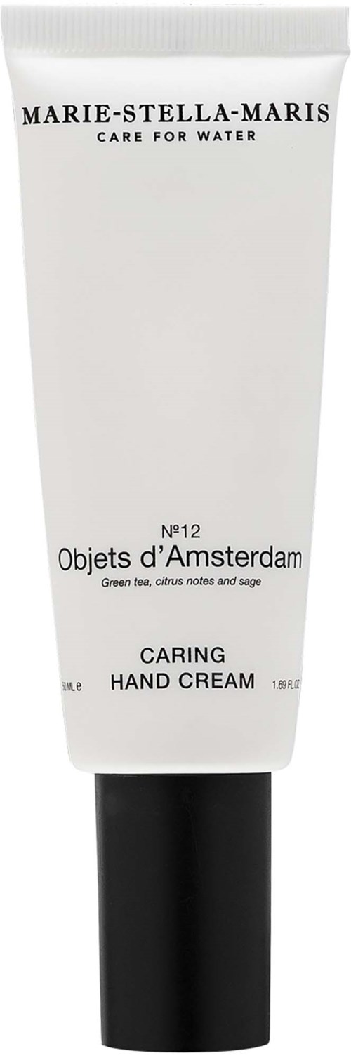 En vit tub med handkräm märkt Marie-Stella-Maris, Objets d'Amsterdam, Caring Hand Cream, med svart lock.