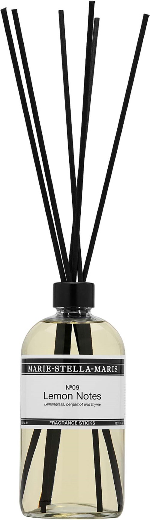 Een fles met zwarte stokjes erin, gelabeld Lemon Notes, die geur verspreiden voor een ruimte.