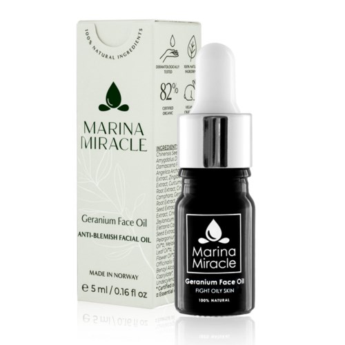 Eine kleine schwarze Flasche mit dem Aufdruck 'Marina Miracle Geranium Face Oil' neben einer weißen Verpackung mit Produktinformationen.