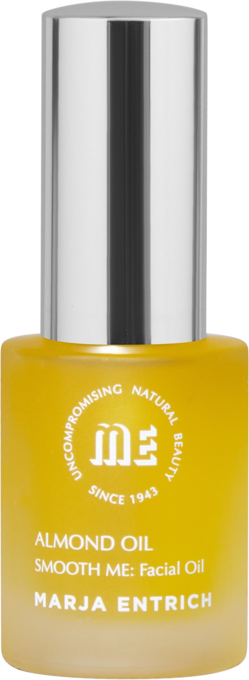 A yellow bottle of facial oil with a silver cap. The label shows the brand and product name.