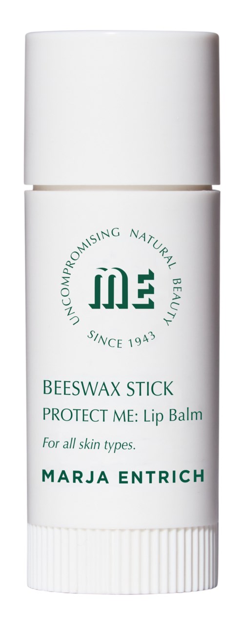 A white lip balm tube with green text, brand logo, and description for all skin types.