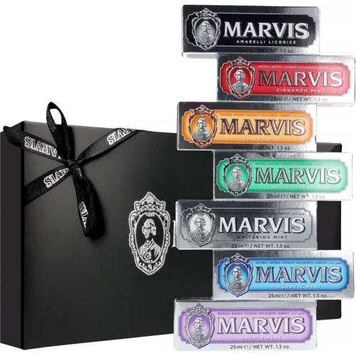 Box of assorted Marvis toothpaste flavors with a black gift box and colorful packaging.