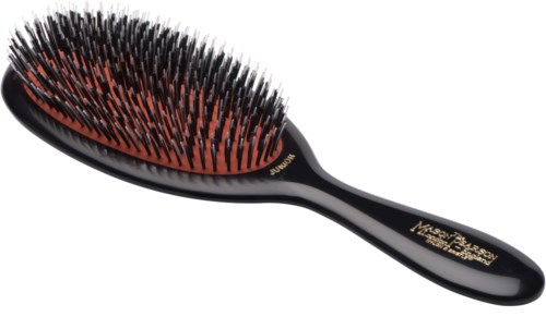A black hairbrush with orange and black bristles, oval shape, and a curved handle.
