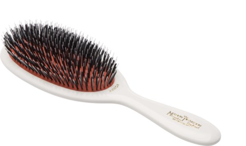 A white hairbrush with black and red bristles lying flat.