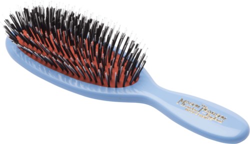 A blue hairbrush with black and orange bristles and a handle that says 'Maxi Passion'.