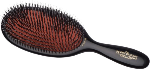 A black hairbrush with red and black bristles, and gold writing on the handle.