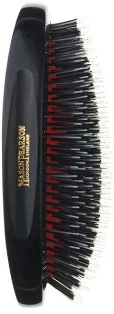 A black grooming brush with red and black bristles, designed for hair or beard care.