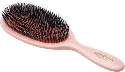 A pink hairbrush with black and orange bristles.