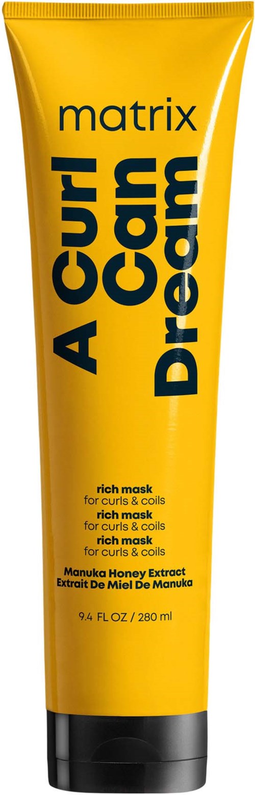 Ein leuchtend gelber Tuben mit schwarzem Text, bezeichnet als reichhaltige Maske für Locken und Coil, enthält Manuka-Honigextrakt.